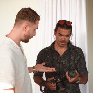 Two photographers comparing cameras at a Lux Photo Club event